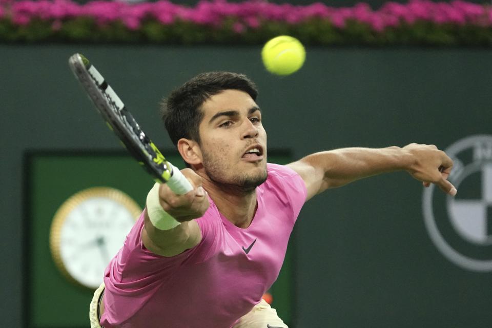 Carlos Alcaraz, of Spain, returns a shot to Felix Auger-Aliassime, of Canada, at the BNP Paribas Open tennis tournament Thursday, March 16, 2023, in Indian Wells, Calif. (AP Photo/Mark J. Terrill)