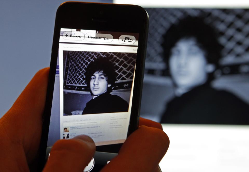 A photograph of Dzhokhar Tsarnaev, a suspect in the Boston Marathon bombing, is seen on his page of Russian social networking site Vkontakte (VK), as pictured on a monitor and a mobile phone in St. Petersburg in this April 19, 2013, file photo. Tsarnaev will learn by late January 2014, whether the U.S. government wants him to die for his role in one of the largest attacks on U.S. soil since September 11, 2001. REUTERS/Alexander Demianchuk/Files (RUSSIA - Tags: CRIME LAW CIVIL UNREST)