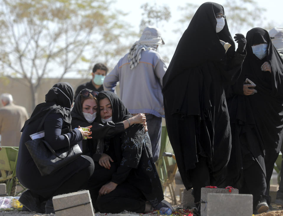 Mourners attend the funeral of a person who died from COVID-19 at the Behesht-e-Zahra cemetery just outside Tehran, Iran, Sunday, Nov. 1, 2020. (AP Photo/Ebrahim Noroozi)