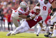 Ohio State's Cody Simon (30) tackles Nebraska quarterback Adrian Martinez (2) during the second half of an NCAA college football game Saturday, Nov. 6, 2021, at Memorial Stadium in Lincoln, Neb. (AP Photo/Rebecca S. Gratz)