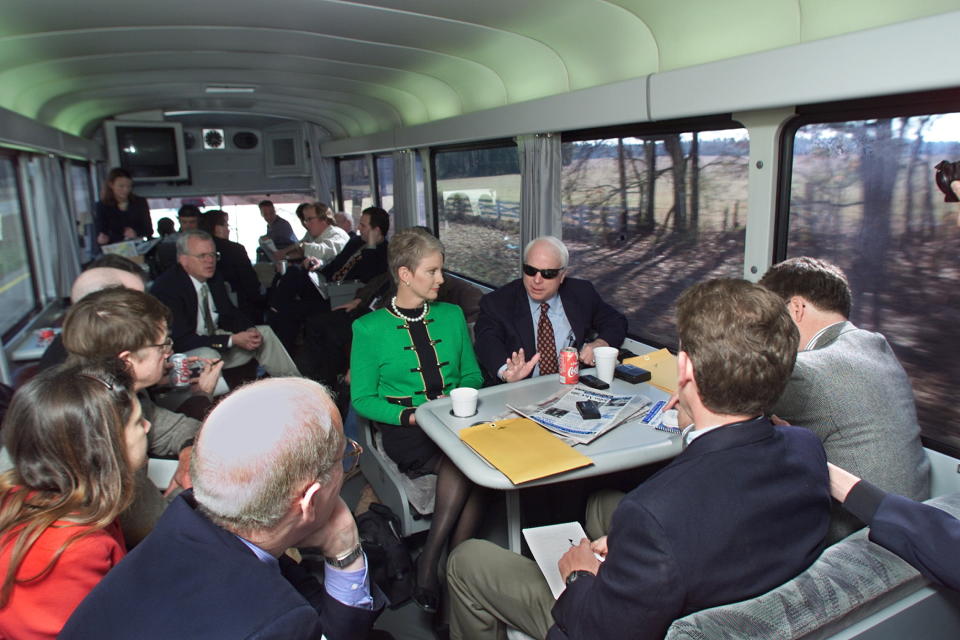 Republican presidential hopeful Sen. John McCain, R-Ariz., and his wife, Cindy, speak with reporters as they travel from Columbia to Sumter, S.C., aboard the “Straight Talk Express” on Jan. 7, 2000. (Photo: Paul J. Richards/AFP/Getty Images)