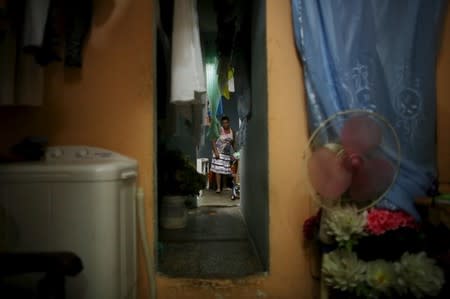 Yolanda Sanchez, 44, walks in her home in downtown Havana, March 19, 2016. REUTERS/Alexandre Meneghini