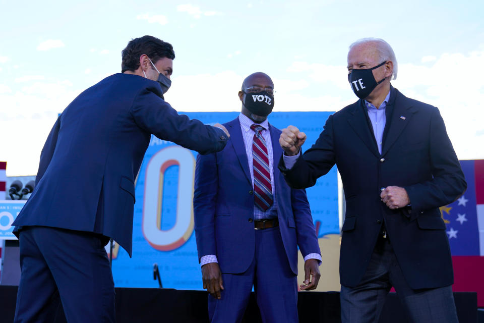 President-elect Joe Biden campaigns in Atlanta, Monday, Jan. 4, 2021, for Senate candidates Raphael Warnock, center, and Jon Ossoff, left. (AP Photo/Carolyn Kaster)                            