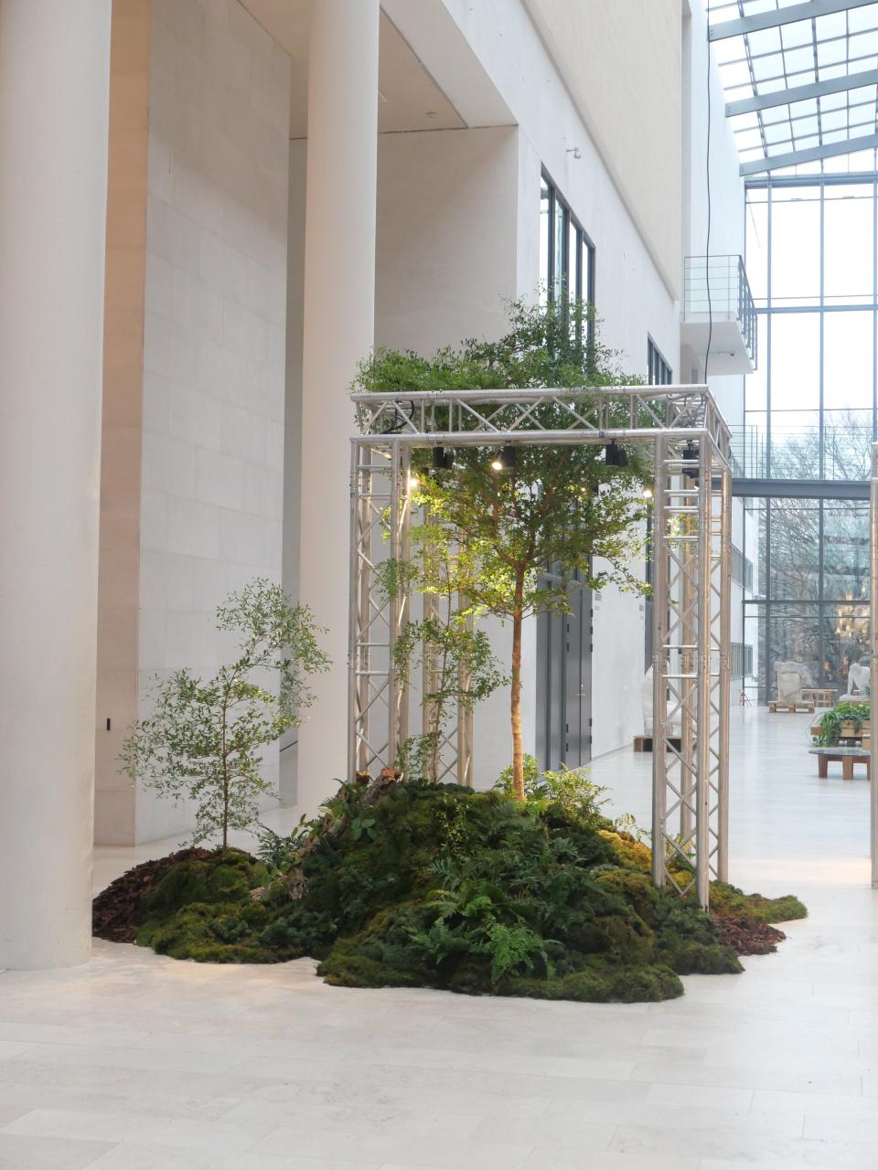 Tableau installation for Zalando. “[We] created a big woody installation for Zalando at Statens Musuem for Kunst in Copenhagen inspired by the urban life style and bringing nature in to our digital world. For the installation a real bucida tree, moss, wood, and ferns was used. It was created upon an underneath structure to give support to the moss, ferns, wood, and roots from the tree.”