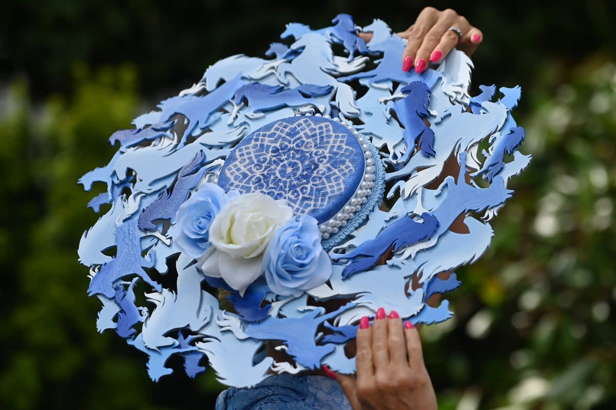 A race-goer with a horse themed hat attends day one of Royal Ascot (EPA)