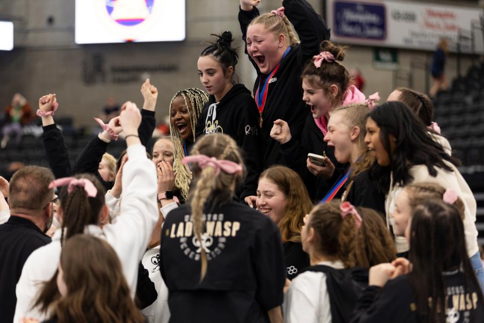 Wasatch High School celebrates a first place win during the 5A Girls Wrestling State Championships at the UCCU Center in Orem on Thursday, Feb. 15, 2024. | Marielle Scott, Deseret News