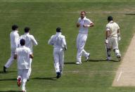 Teammates run to England's Stuart Broad (2nd R) after he dismissed Australia's David Warner (R) during the first day's play of the second Ashes test cricket match in Adelaide December 5, 2013.