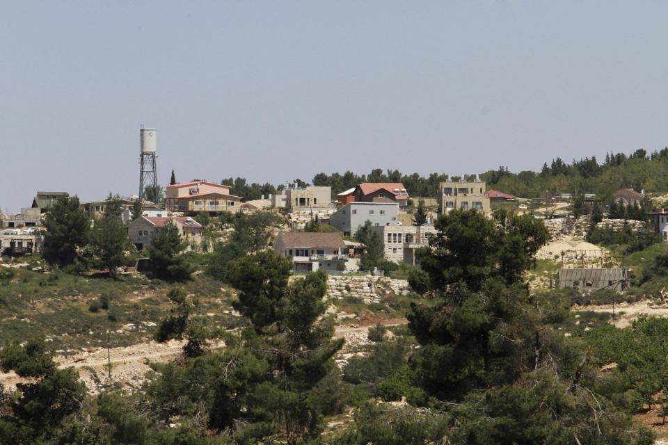 This Friday, April 18, 2014 photo shows the Jewish settlement of Bat Ayin, north of the West Bank city of Hebron. The settlement is known for its hardline population. While Israeli settlers in the West Bank fall mostly under civilian rule, Palestinians are subject to Israeli military law. Israeli and Palestinian youths face inequities at every stage in the path of justice, from arrests to convictions and sentencing, according to police statistics obtained by The Associated Press through multiple requests under Israel's freedom of information law. (AP Photo/Nasser Shiyoukhi)