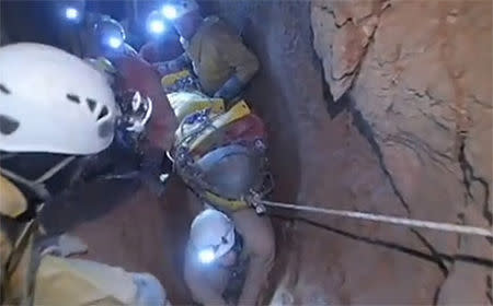 Rescuers help injured researcher Johann Westhauser inside the Riesending cave in Untersberg, south of Munich in this still image taken from video from a camera mounted on the helmet of a rescuer released by Bavaria's mountain rescue team "Bergwacht Bayern" on June 16, 2014. REUTERS/Bergwacht Bayern/Handout via Reuters TV