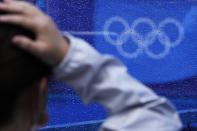 Rainwater covers a window after a rain storm at a field hockey match at the 2020 Summer Olympics, Tuesday, July 27, 2021, in Tokyo, Japan. (AP Photo/John Locher)