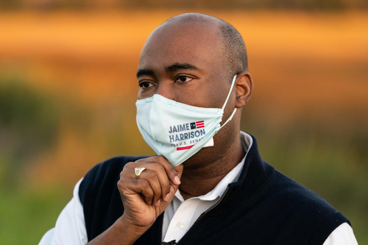 Democratic Senate candidate Jaime Harrison adjusts his mask while speaking to the media after a drive-in rally on October 17, 2020 in North Charleston, South Carolina. Harrison is running against incumbent Sen. Lindsey Graham (R-SC). (Photo by Cameron Pollack/Getty Images)