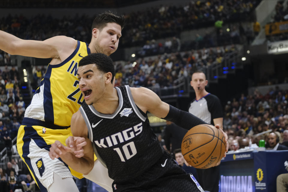 Sacramento Kings guard Justin James (10) goes around Indiana Pacers forward Doug McDermott (20) during the first half of an NBA basketball game in Indianapolis, Friday, Dec. 20, 2019. (AP Photo/AJ Mast)