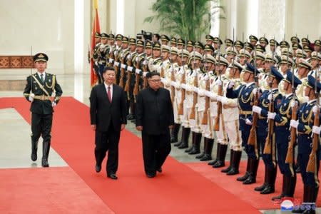 North Korean leader Kim Jong Un walks beside Chinese President Xi Jinping in Beijing, China, in this undated photo released June 20, 2018 by North Korea's Korean Central News Agency. KCNA via REUTERS