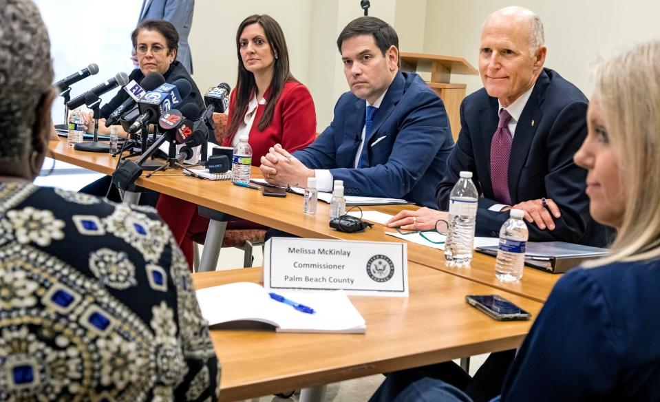Florida Sens. Marco Rubio (left) and Rick Scott (right) listen to Palm Beach County Administrator Verdenia Baker during a press event about the coronavirus at the Palm Beach County Health Department in West Palm Beach in March 2020.