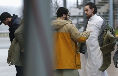 Bilal El Makhoukhi (L) and Michael Delefortrie (R), who are suspected of being part of "Sharia4Belgium", arrive for the verdict in the trial of the group in Antwerp February 11, 2015. REUTERS/Francois Lenoir