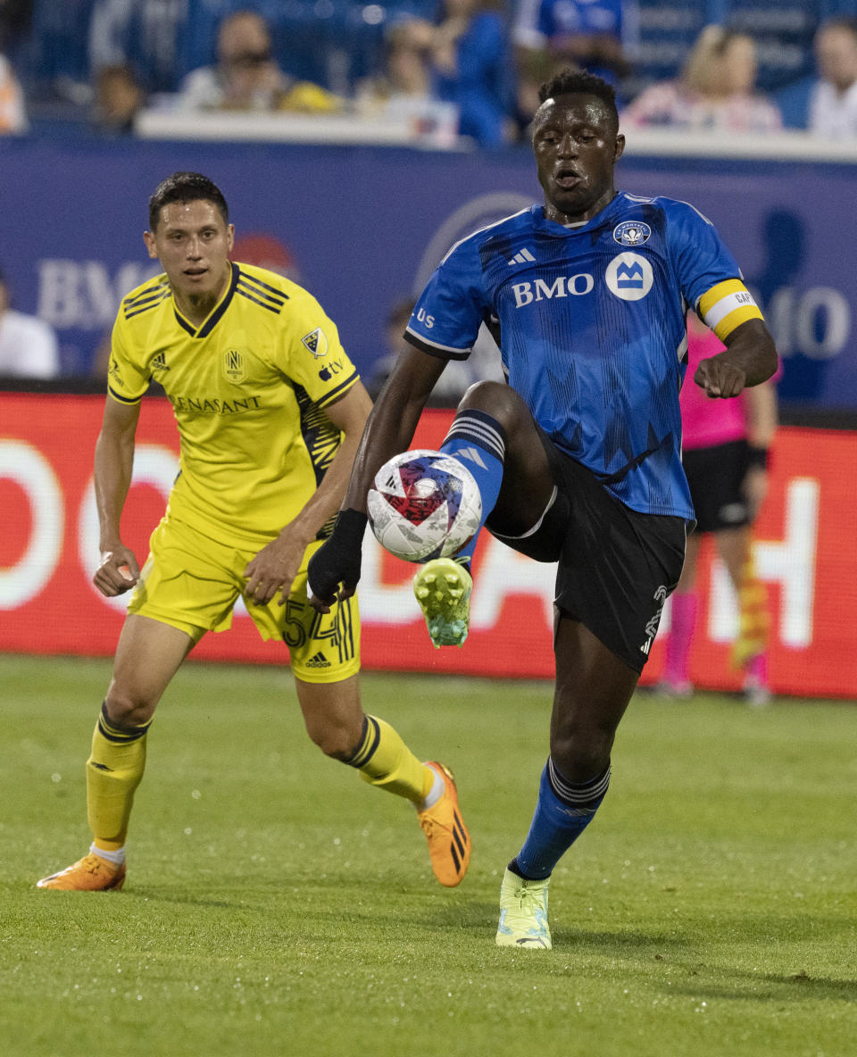 CF Montreal midfielder Victor Wanyama controls the ball as Nashville SC midfielder Sean Davis (54) watches during the second half of an MLS soccer match Wednesday, June 21, 2023, in Montreal. (Christinne Muschi/The Canadian Press via AP)