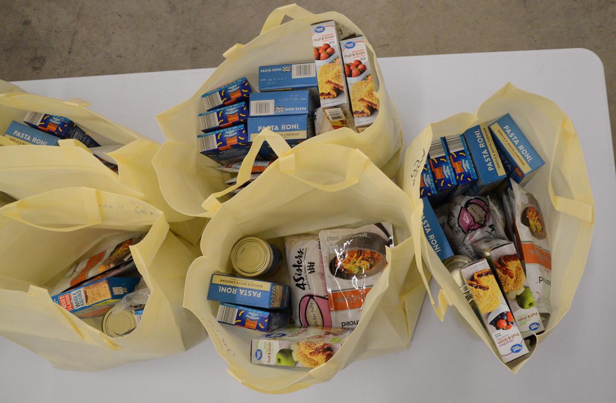 Some of the food bags filled by The Table's Tilly Grace, Libbie Hall and other volunteers are shown.