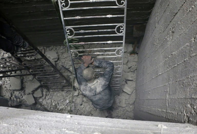 A Syrian man reacts at the site of Syrian government bombardments in Douma, in the besieged Eastern Ghouta region on February 22, 2018