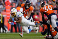 Los Angeles Chargers running back Austin Ekeler (30) dives into the end zone for a touchdown as Denver Broncos inside linebacker Kenny Young (41) defends during the first half of an NFL football game, Sunday, Nov. 28, 2021, in Denver. (AP Photo/Jack Dempsey)