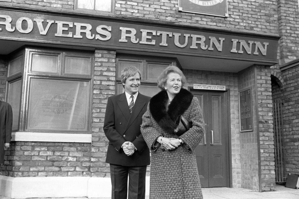 Prime Minister Margaret Thatcher outside the Rovers Return with William Roache, who plays Ken Barlow, on her visit to the Coronation Street set at Granada Studios, Manchester.   (Photo by John Giles/PA Images via Getty Images)