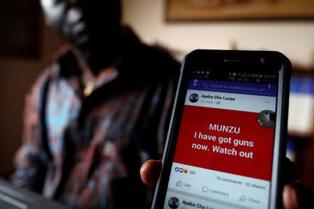 Simon Munzu, a former UN official, who is campaigning for peace in the Anglophone regions of Cameroon, shows a threat message posted against him on social media by separatists during an interview with Reuters in Yaounde, Cameroon October 3, 2018. Picture taken October 3, 2018. REUTERS/Zohra Bensemra