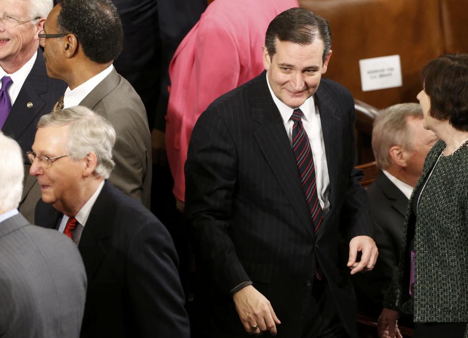 Republican U.S. Senator Cruz of Texas walks past U.S. Senate Majority Leader McConnell as he arrives for U.S. President Obama's State of the Union address to a joint session of the U.S. Congress on Capitol Hill in Washington