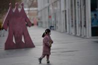 A child wears a face mask in Beijing's central business district