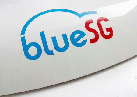 A BlueSG logo is pictured on an electric car-sharing vehicle parked at a charging station in a public housing estate in Singapore December 12, 2017. REUTERS/Edgar Su