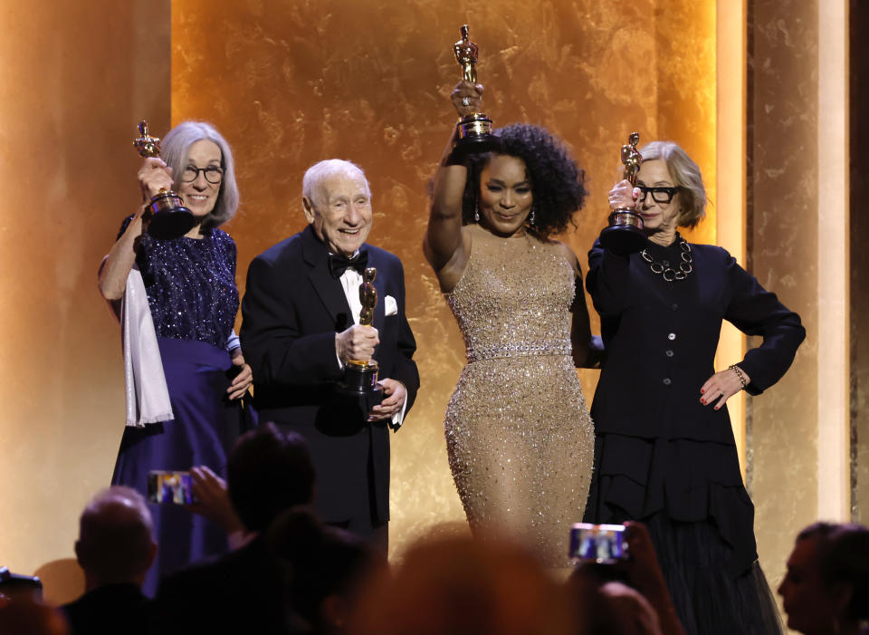 Carol Littleton, Mel Brooks, Angela Bassett and Michelle Satter stand onstage holding their Oscars