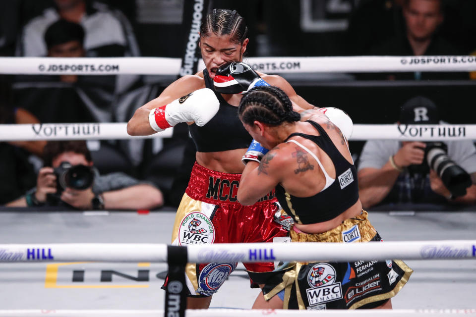 Erica Farias, right, hits Jessica McCaskill during a super lightweight boxing bout Saturday, Oct. 12, 2019, in Chicago. (AP Photo/Kamil Krzaczynski)