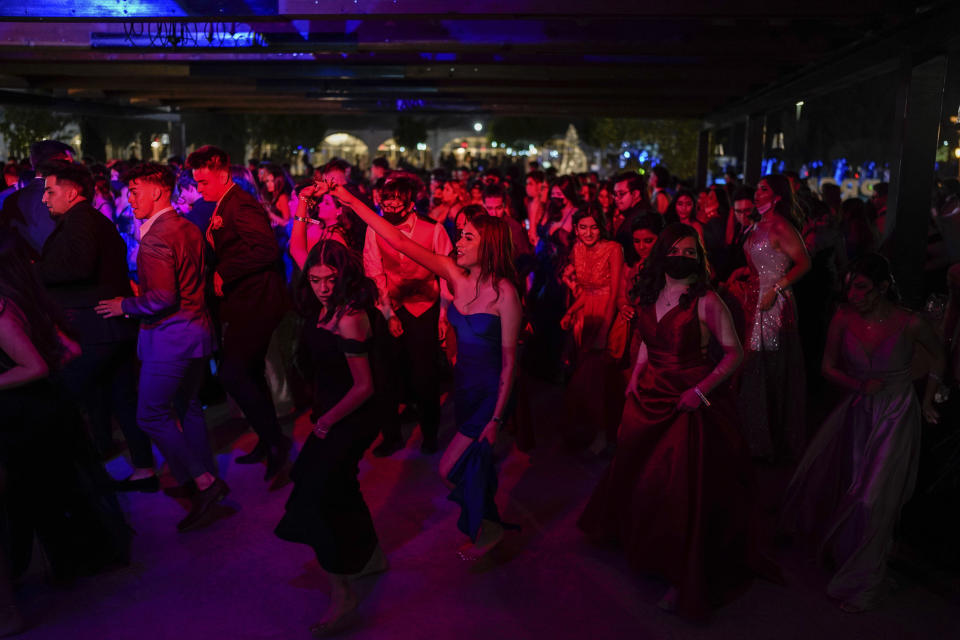 Young people attend prom at the Grace Gardens Event Center in El Paso, Texas on Friday, May 7, 2021. Around 2,000 attended the outdoor event at the private venue after local school districts announced they would not host proms this year. Tickets cost $45. (AP Photo/Paul Ratje)