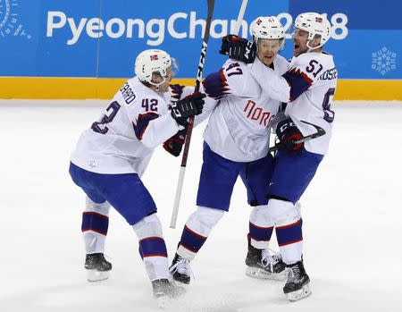 Ice Hockey - Pyeongchang 2018 Winter Olympics - Men's Playoff Match - Slovenia v Norway - Gangneung Hockey Centre, Gangneung, South Korea - February 20, 2018 - Alexander Bonsaksen of Norway celebrates with teammates after scoring a goal in overtime to defeat Slovenia. REUTERS/Grigory Dukor