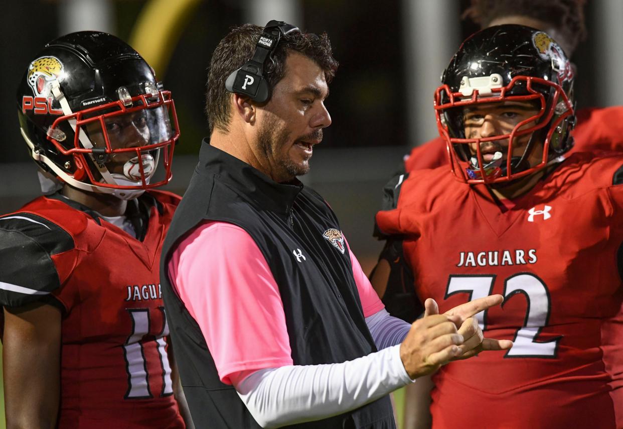 Port St. Lucie High School head coach Chris Dent instructs his team as the Jaguars played Okeechobee in a District 8-6A football game on Friday, Oct. 15, 2021, at PSL High School's stadium in Port St. Lucie. Port St. Lucie won against Okeechobee 34-7.