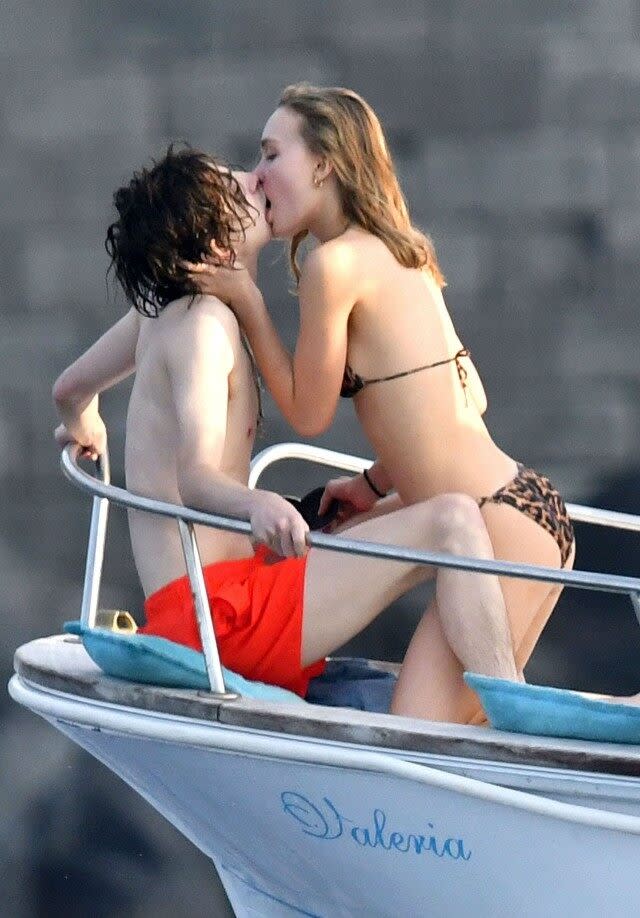The co-star couple poured on the PDA on a yacht in Capri, Italy.