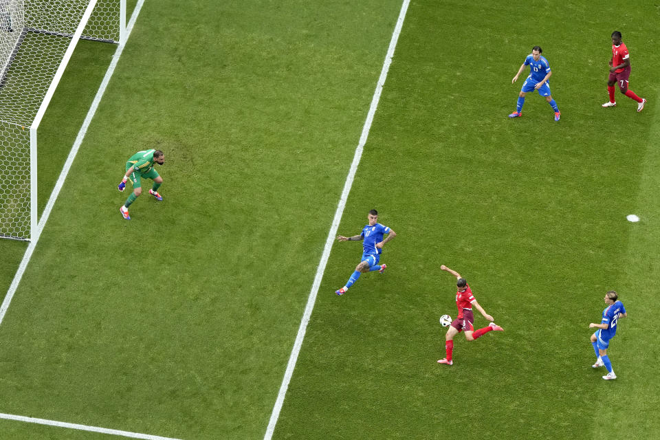 Switzerland's Remo Freuler, bottom left, scores the opening goal during a round of sixteen match between Switzerland and Italy at the Euro 2024 soccer tournament in Berlin, Germany, Saturday, June 29, 2024. (AP Photo/Markus Schreiber)