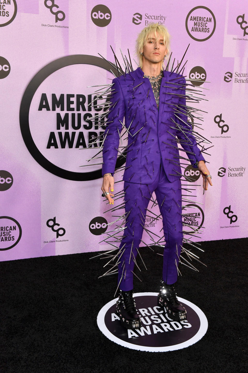 Machine poses in his very spiked suit