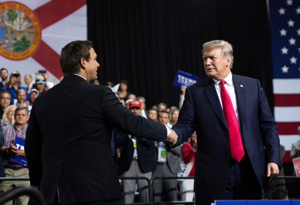 Then-President Donald Trump shakes hands with then-Rep. Ron DeSantis at a campaign rally in Tampa, Fla. (Saul Loeb / AFP via Getty Images)