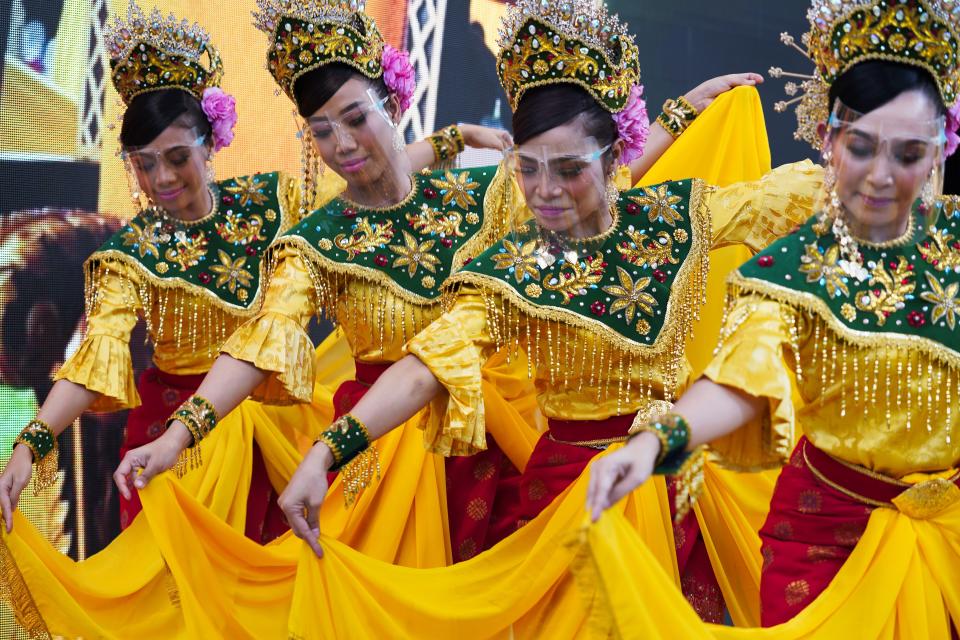 Dancers from Malaysia's pavilion perform wearing face shields due to the coronavirus at Expo 2020, in Dubai, United Arab Emirates, Sunday, Oct. 3, 2021. (AP Photo/Jon Gambrell)