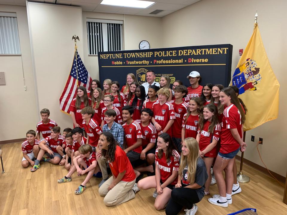 The newly sworn in Deputy Chief Michael McGhee celebrates with the Neptune travel soccer program, where he also serves as a member of the board and coach.