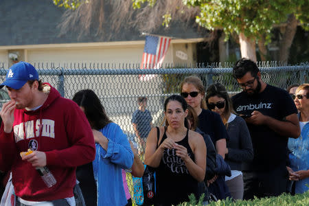 People wait in line to donate blood outside LaReina High School after a mass shooting by a lone gunman at a bar in Thousand Oaks, California, U.S. November 8, 2018. REUTERS/Mike Blake