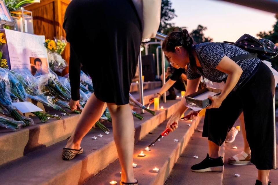 Candles are lit and flowers are laid on the steps of the Cary Arts Center in memory of UNC-Chapel Hill professor Zijie Yan during a candlelight vigil organized by the Chinese American Friends Association of North Carolina and and North Carolina Asian Americans Together on Tuesday evening, Sept. 5, 2023. Yan was shot and killed on campus on Monday, Aug. 28.