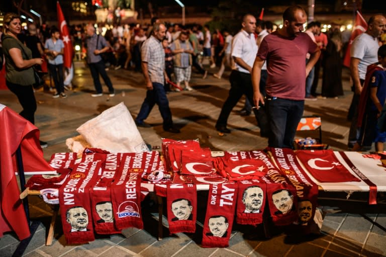 A man sells scarves with pictures of Turkish President Recep Tayyip Erdogan during a pro-Erdogan rally in Taksim square in Istanbul