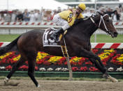 FILE - Jockey Calvin Borel gestures as he rides Rachel Alexandra to victory in the 134th running of the Preakness Stakes horse race at Pimlico Race Course in Baltimore, in this Saturday, May 16, 2009, file photo. The Preakness is the first horse race to release one of a kind digital souvenirs to auction off, NFTs like the ones Super Bowl champion Rob Gronkowski and the NBA’s Golden State Warriors did. Officials see it as a chance for horse racing to reach a younger audience. (AP Photo/Peter Morgan, File)