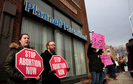 Anti-abortion activists (L) rally next to supporters of Planned Parenthood outside a Planned Parenthood clinic in Detroit, Michigan, U.S. February 11, 2017. REUTERS/Rebecca Cook