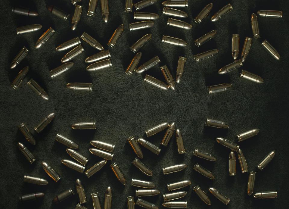 Bullets are scattered about a table top.