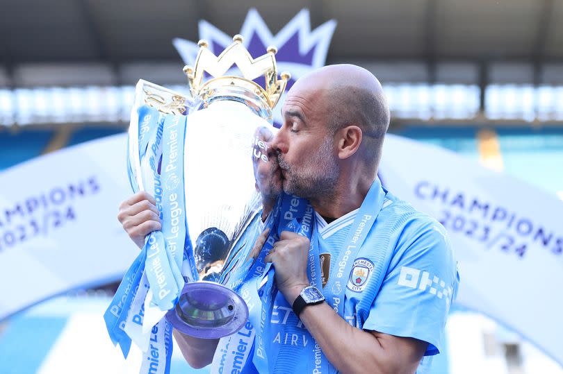 Pep Guardiola celebrates with the Premier League title