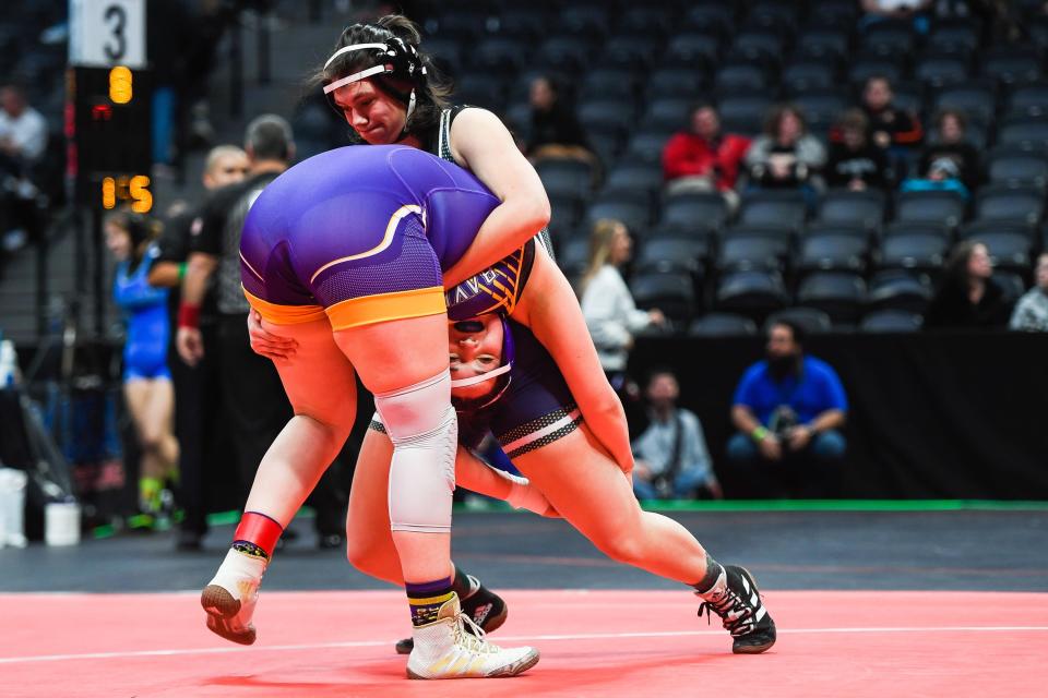 Poudre School District's Ezry Bonomo, right, wrestles Bayfield's Gracie Patton at the Colorado state high school wrestling tournament at Ball Arena on Thursday, Feb. 16, 2023 in Denver, Colo. Bonomo won with a pin in the first round,