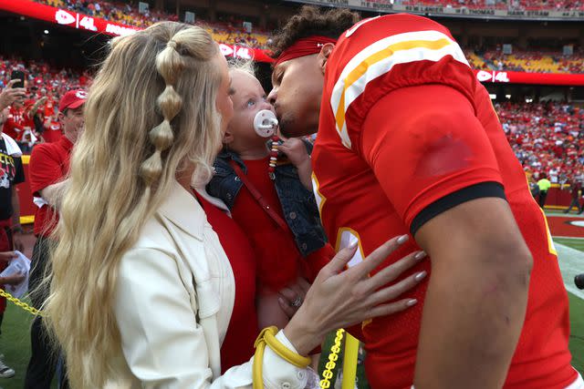 <p>Jamie Squire/Getty</p> Patrick Mahomes kisses his daughter, Sterling