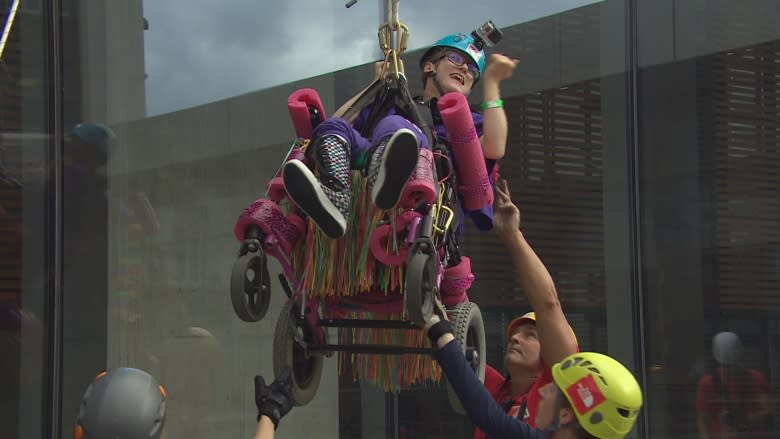 Teen with cerebral palsy rappels down Winnipeg skyscraper in her wheelchair for charity