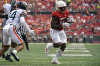 Louisville running back Jalen Mitchell (15) runs past the defense of Virginia defensive back Antonio Clary (14) to cross the goal line for a touchdown during the second half of an NCAA college football game in Louisville, Ky., Saturday, Oct. 9, 2021. Virginia won 34-33. (AP Photo/Timothy D. Easley)